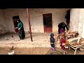 Life in the village: chopping firewood on a rainy day