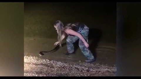 Brave girl wrangles massive python with her bare hands
