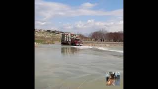 Oversize and heavy load passing a river ! Mack power !