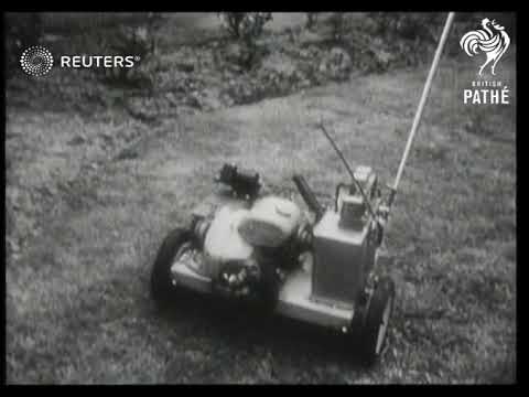 Man displays radio controlled lawn mower (1950)