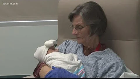 Volunteers rock babies at Macon's Beverly Knight O...