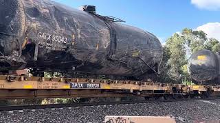 BNSF mixed freight train with wrecked tank cars