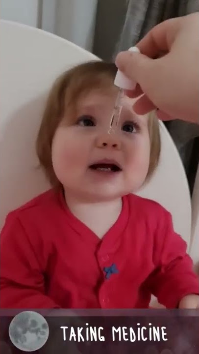 Cute baby is happy to take her medicine drop