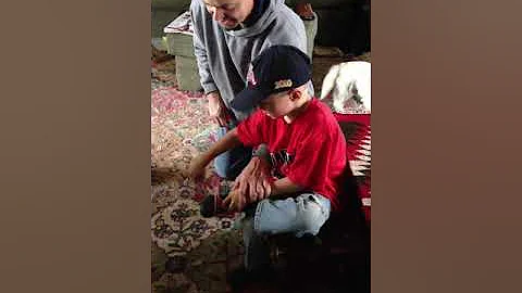 Ronnie teaching Jace how to tie his foot 2