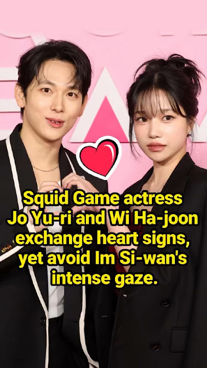 Squid Game actress Jo Yu-ri and Wi Ha-joon exchange heart signs, yet avoid Im Si-wan's intense gaze.