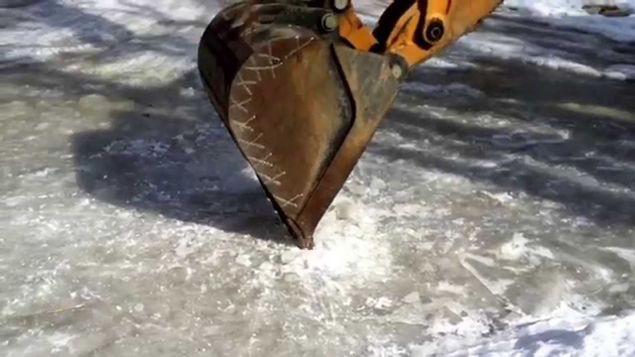 Backhoe digging ice - YouTube