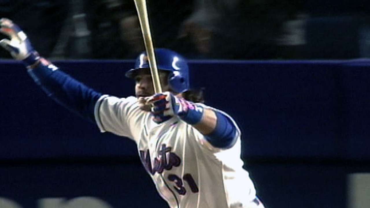 Carl Everett of the New York Mets, center, dives back to first base while Eric  Karros of the Los Angeles Dodgers, left, takes the throw from the pitcher  as Mets first base