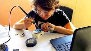 Robolink student soldering for SeaPerch Underwater robotics competition