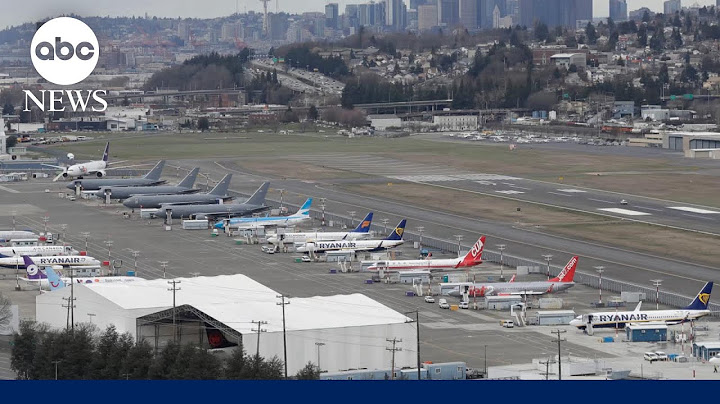 Unruly plane passenger tried to open emergency door, officials say