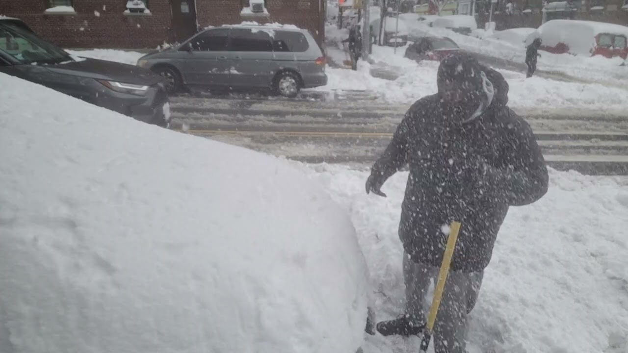 PAKE & SELT shoveling snow in the streets of Washington Heights NYC.