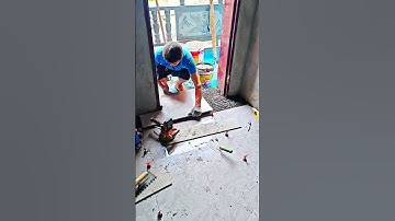 The process of installing floor tiles near a doorway
