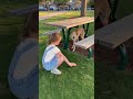 Little girl gives stray dog food.