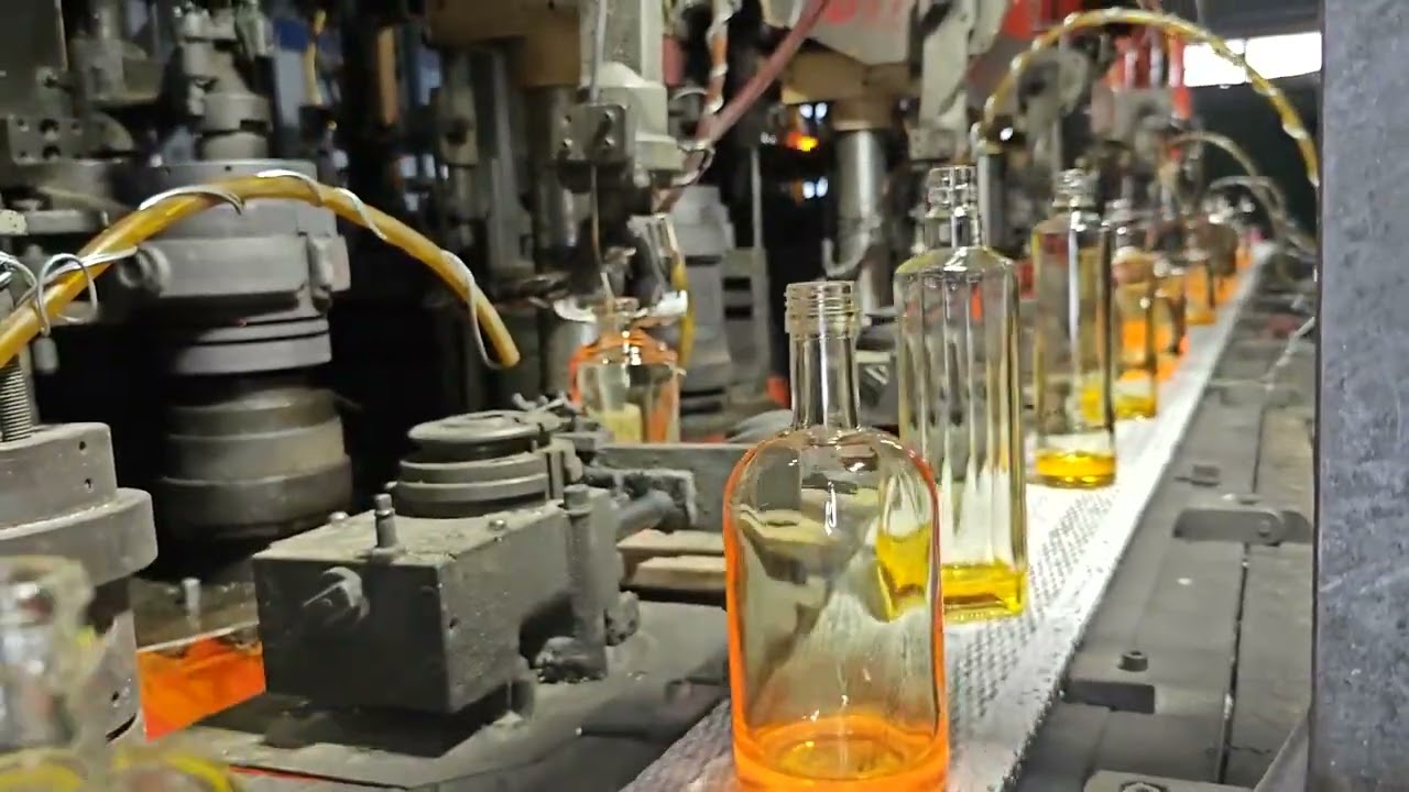 Watch our freshly produced glass bottles smoothly passing through the hot-end conveyor belt.