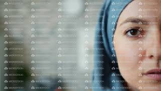 Close-up portrait of Muslim woman in hijab half face on brick wall background screenshot 1