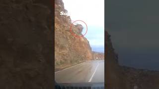 Terrifying moment sudden landslide buries car as huge rocks fall from hillside