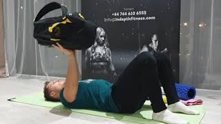 Single arm backpack floor press