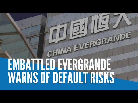 Embattled Evergrande warns of default risks