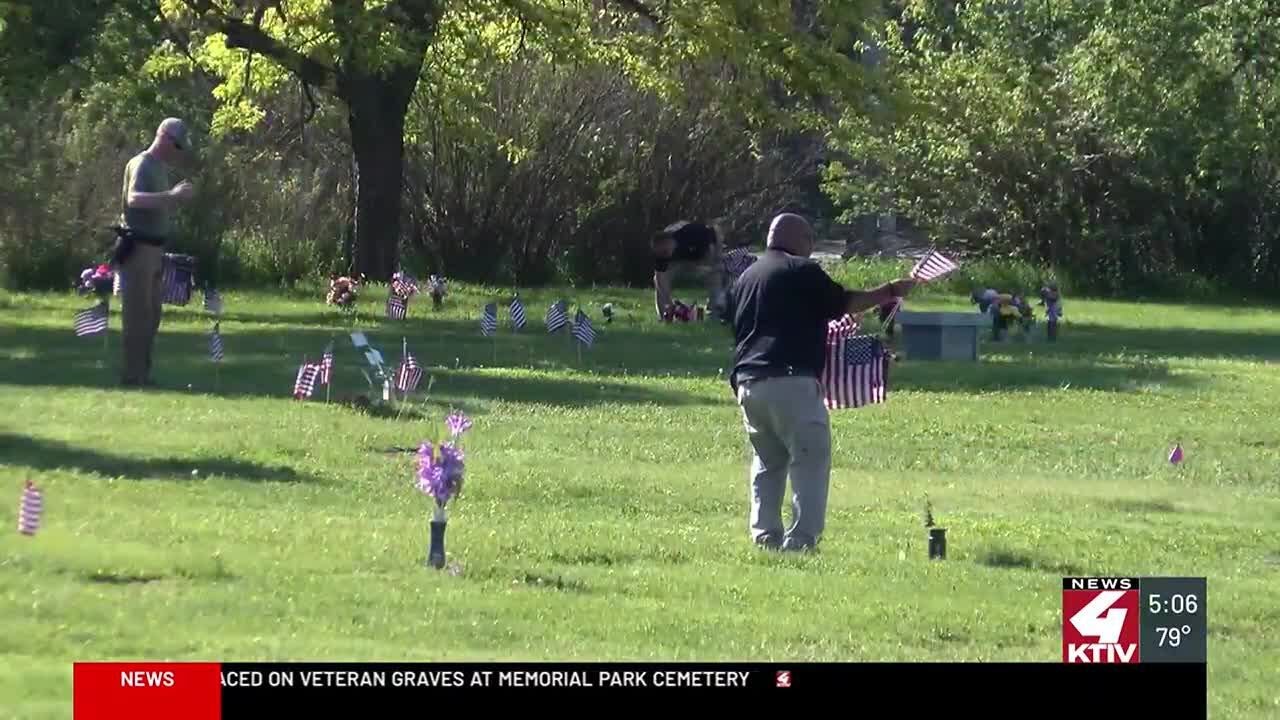 Thousands of flags placed on veteran graves at Memorial Park Cemetery ...