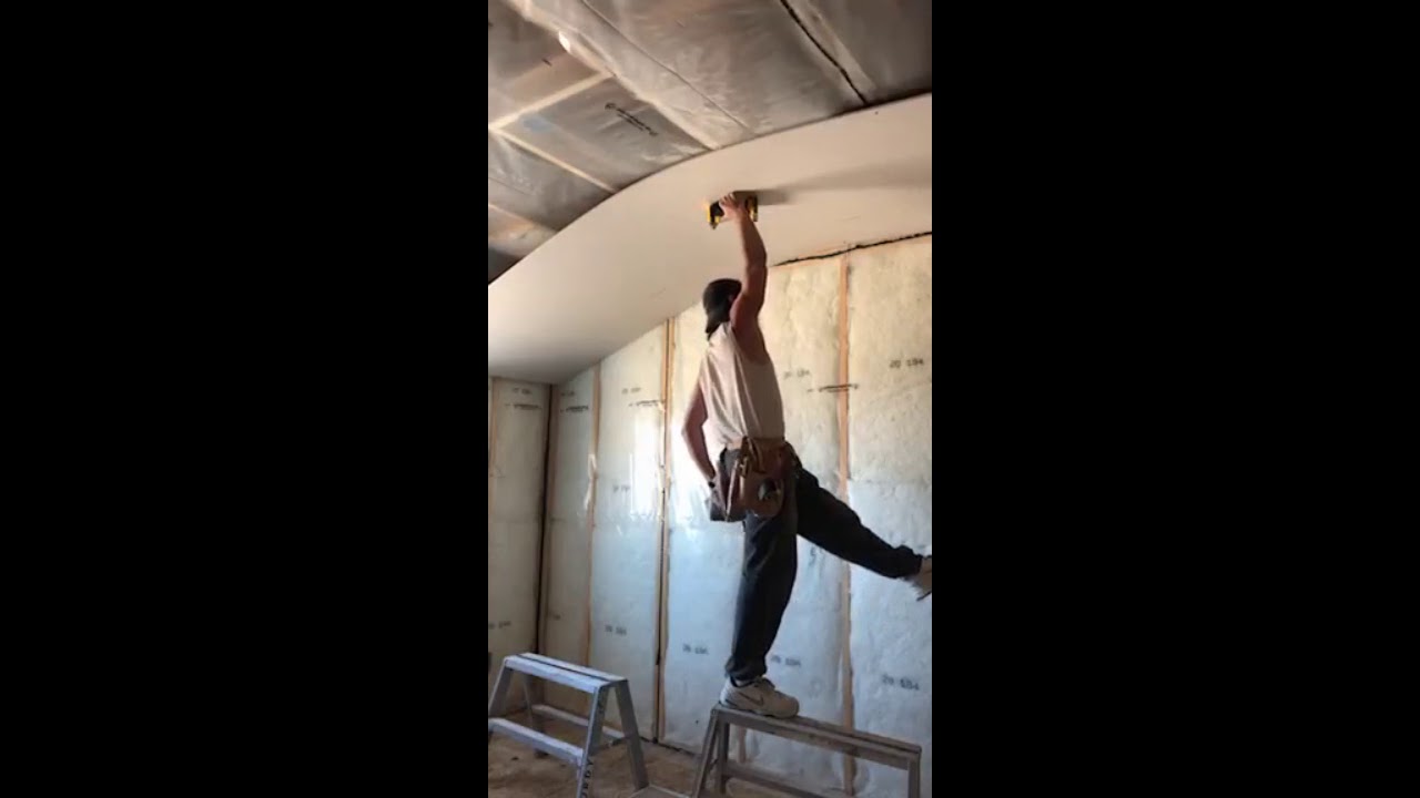 1 Guy installing a Full 12' sheet of drywall on the ceiling with no