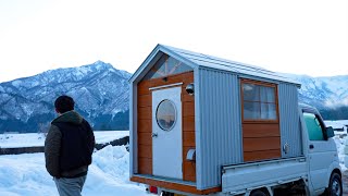 Homemade truck camper in the snow. Enjoy hot pot and snowboarding