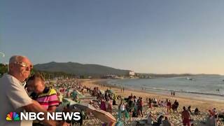 Beachgoers in Spain revel in total solar eclipse