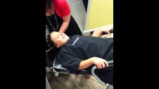 Boy can't stop laughing at haircut