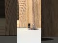 A small tool on wood marks the distance and size differences between each drilled hole accurately.