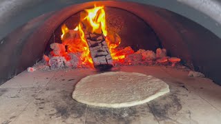 Cooking naan bread in Joe barrel wood fired DIY pizza oven