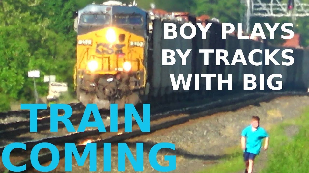 bnsf 5729 Boy Playing By Tracks with Freight Train Coming