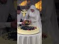 Bride And Groom Decorating The Cake 