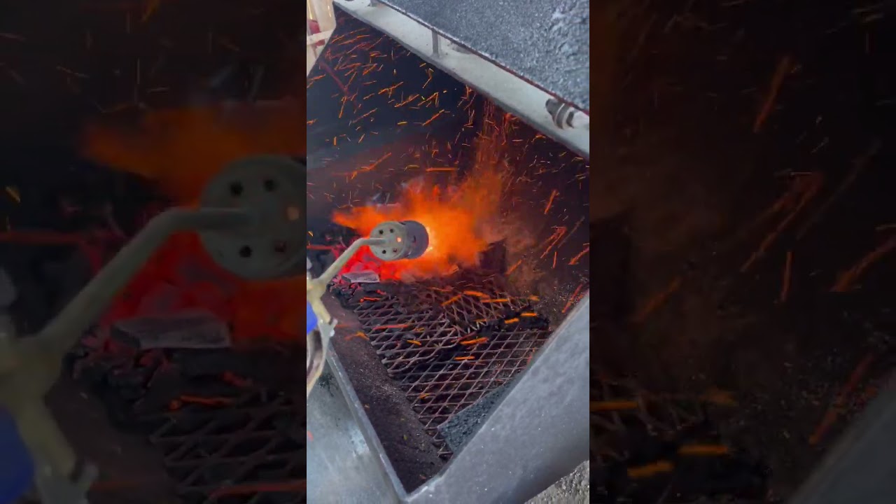 The sparks are flying on a new bag of frontier lump charcoal being lit with my handy propane torch