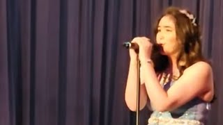 Justina sings Rise by Katy Perry.