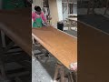 The stage of installing a wooden patterned lesson on the table is carried out by an expert