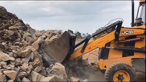 JCB 3DX Super Loading stone into a dump truck