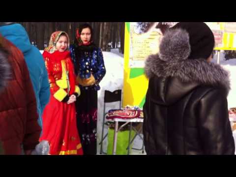 Spring celebration in Russia, snow fun traditional costumes, happy people outdoor. Stock footage