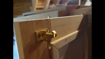 Bookcase door opening with key and latches.