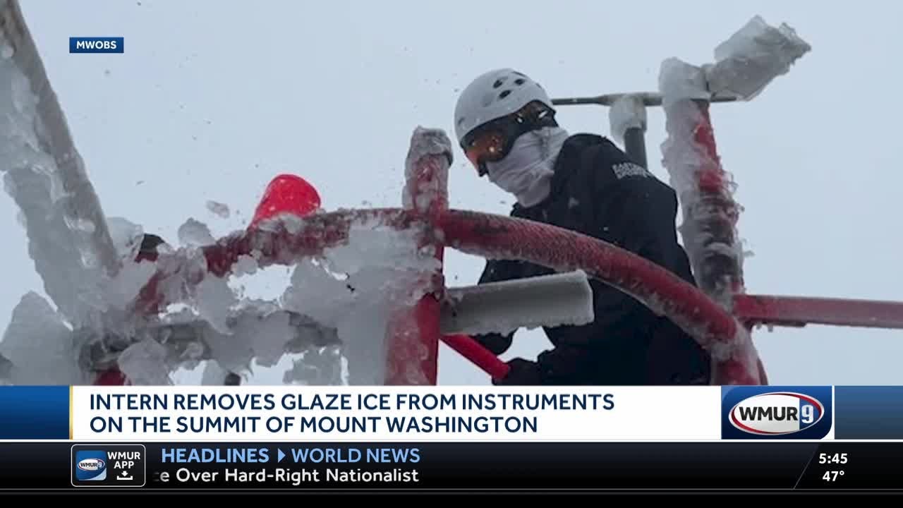 Intern removes glaze ice from instruments on the summit of Mount Washington