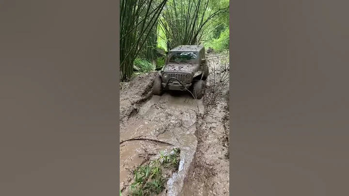 Off road in big rain mud trail with Jeep Wrangler JL