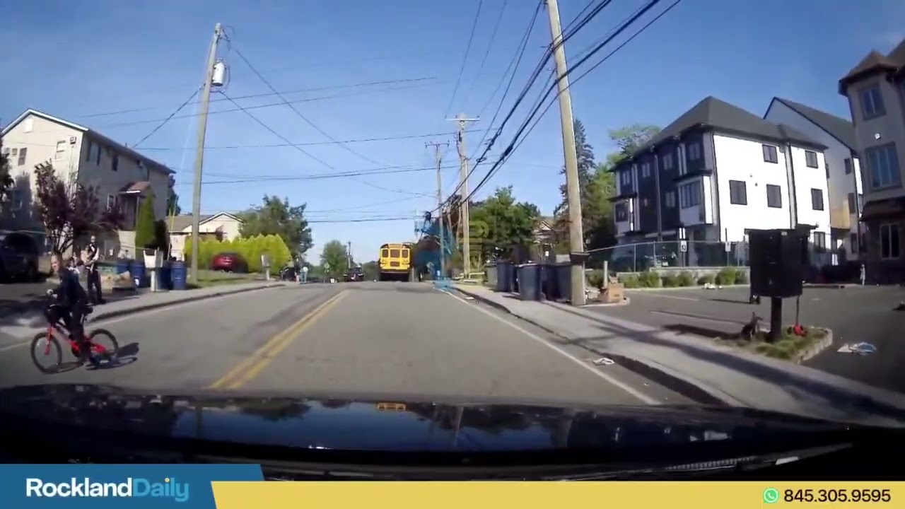 Child riding a bicycle attempts to cross in middle of the street, as a car is driving on Cedar Lane
