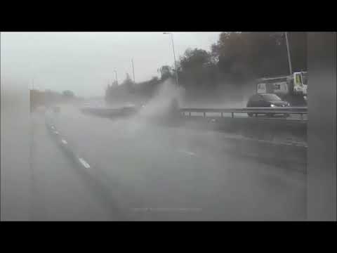 Terrifying moment BMW "doing 90mph" in atrocious weather aquaplanes and hits safety barrier