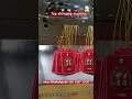 Hang tag stringing machine