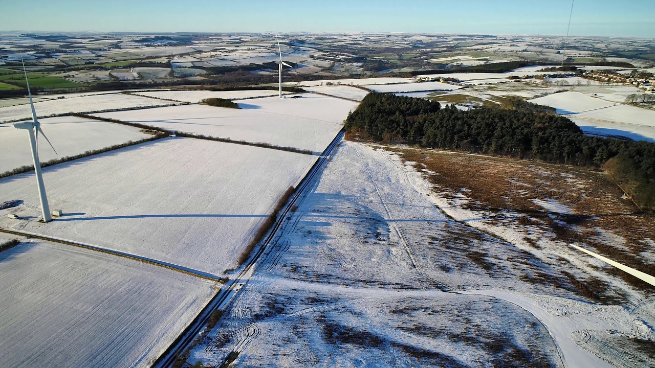 Wind turbines and Burnhope area Co Durham UK in the snow by drone.