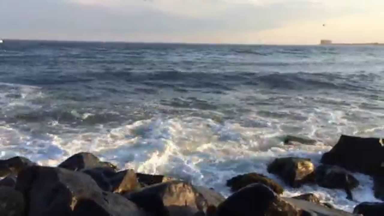 Ocean waves kicking up Longport , NJ jetty