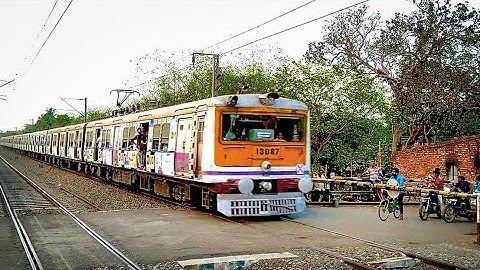 Honking 9 Coach EMU Train Speedily Crossing Busy Railgate | Advertise Painted colorful EMU Train