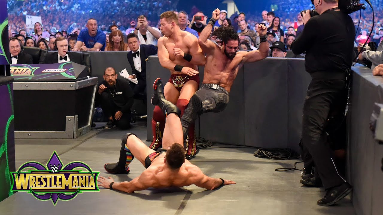 Finn Bálor drives Seth Rollins and Miz into the ringside barricade: WrestleMania 34 (WWE Network)