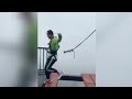 Asian Guy Swinging From Neck Workout