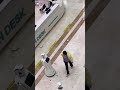 Moment a woman flips out at robot receptionist and smashes it up