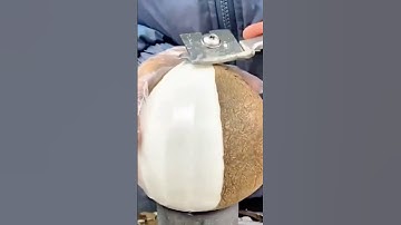 Peeling young coconuts with a sharp knife until the skin is clean and smooth #shorts