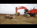 Hitachi Zaxis 670LCH-5 loads Komatsu HM400-3