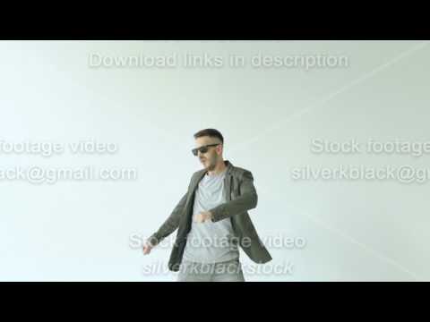 slowmotion-of-young-funny-man-in-sunglasses-crazy-dancing-on-white-background